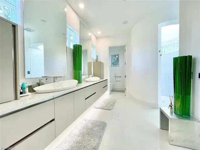 a en suite bathroom with a sink double vanity and a mirror