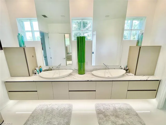 a living room with a couch and a potted plant