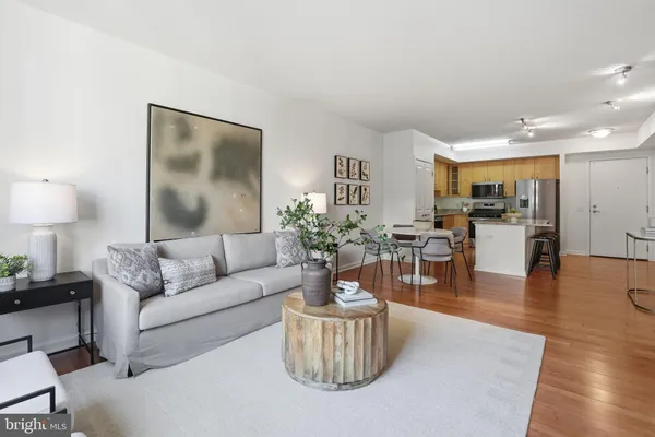 a living room with furniture and wooden floor