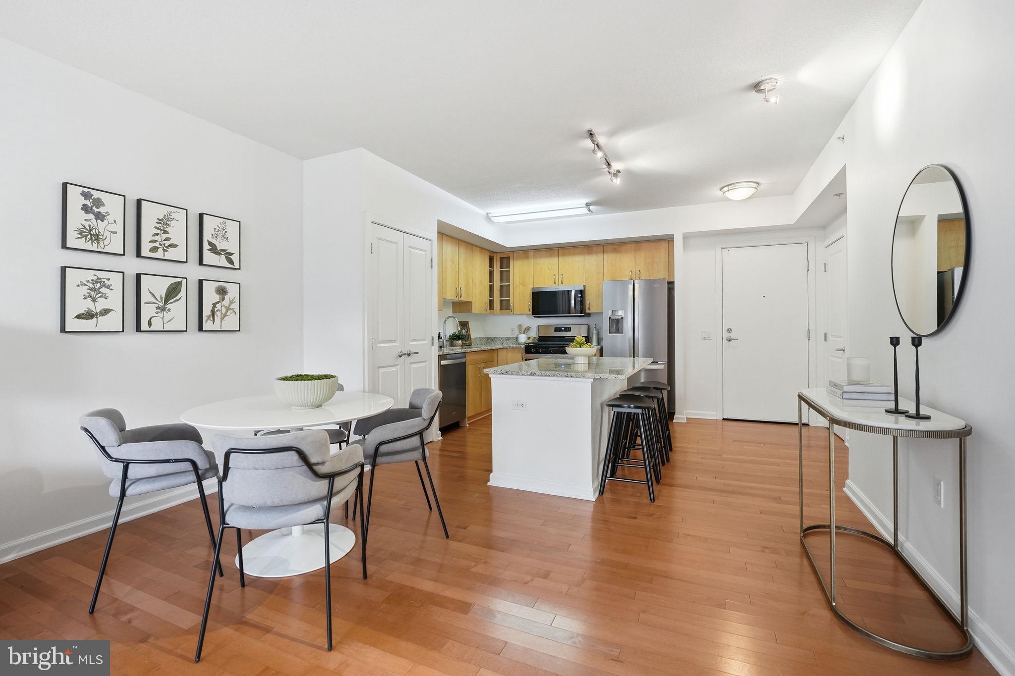 440 L Street Northwest, Unit 809 Washington, DC 20001 - Photo 12 of 50 a view of a dining room with furniture and wooden floor