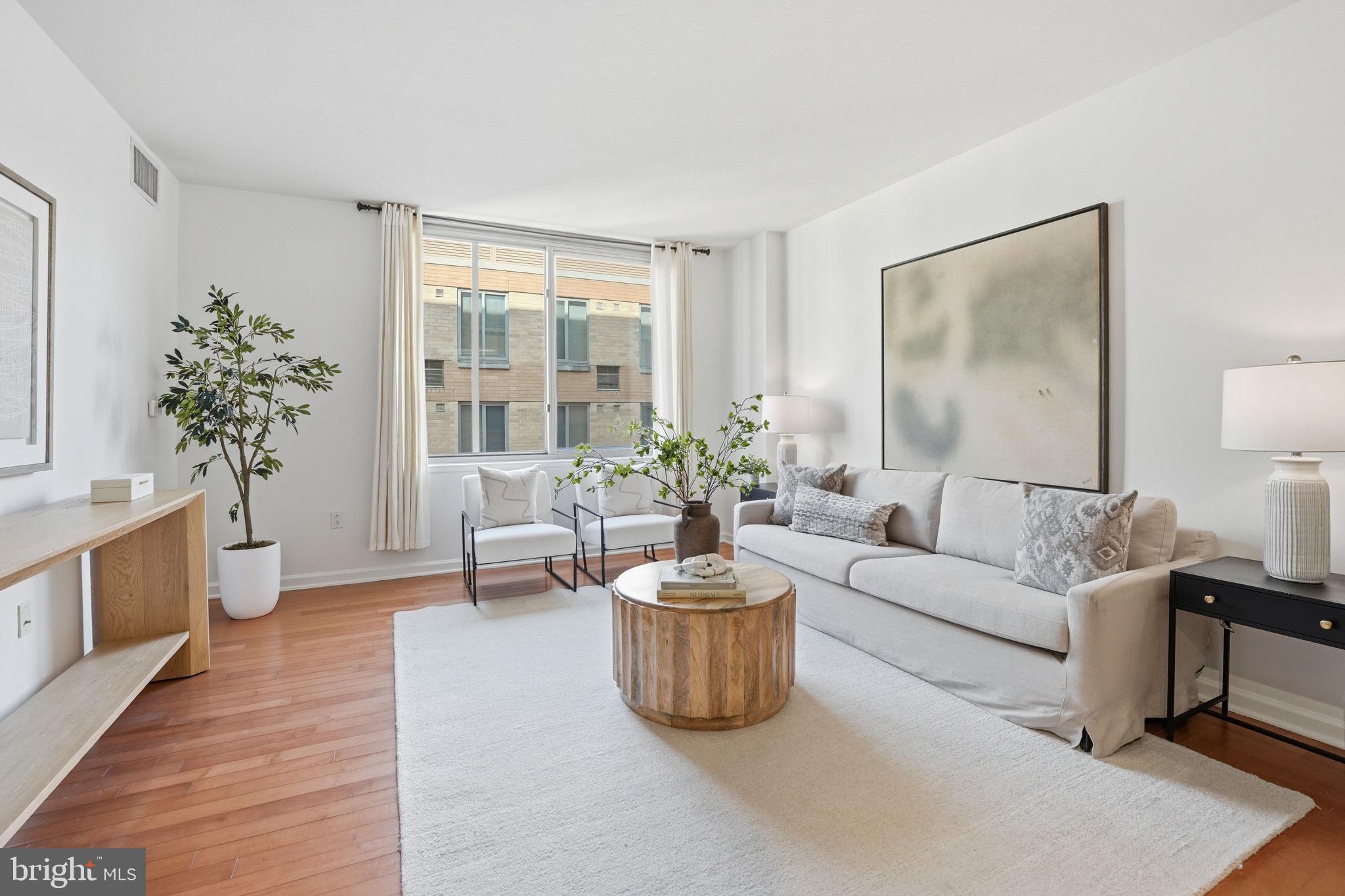440 L Street Northwest, Unit 809 Washington, DC 20001 - Photo 13 of 50 a living room with furniture and a potted plant