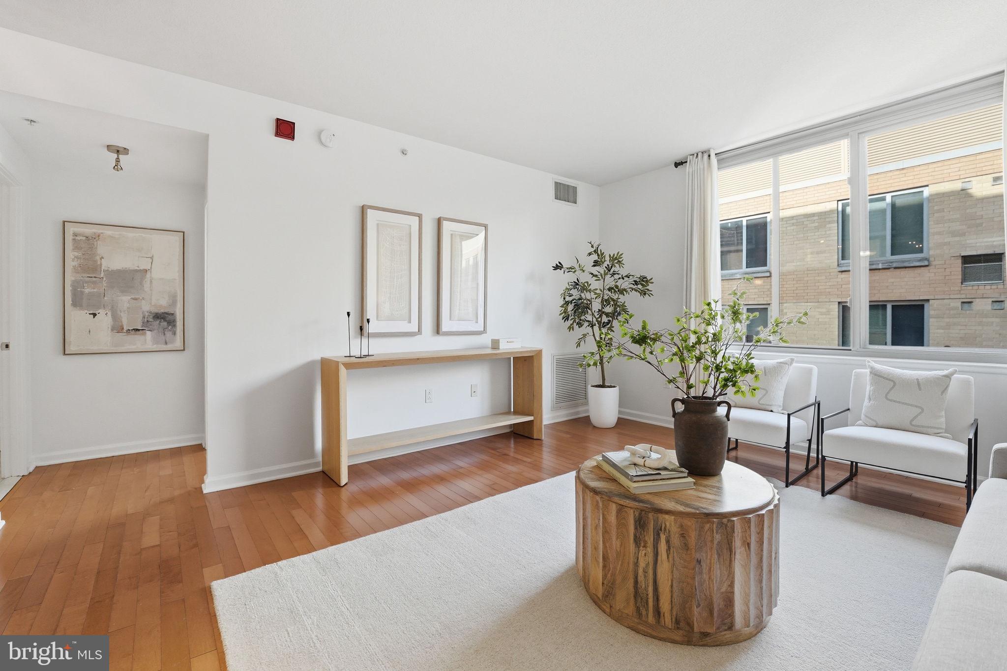 440 L Street Northwest, Unit 809 Washington, DC 20001 - Photo 14 of 50 a living room with furniture and potted plant