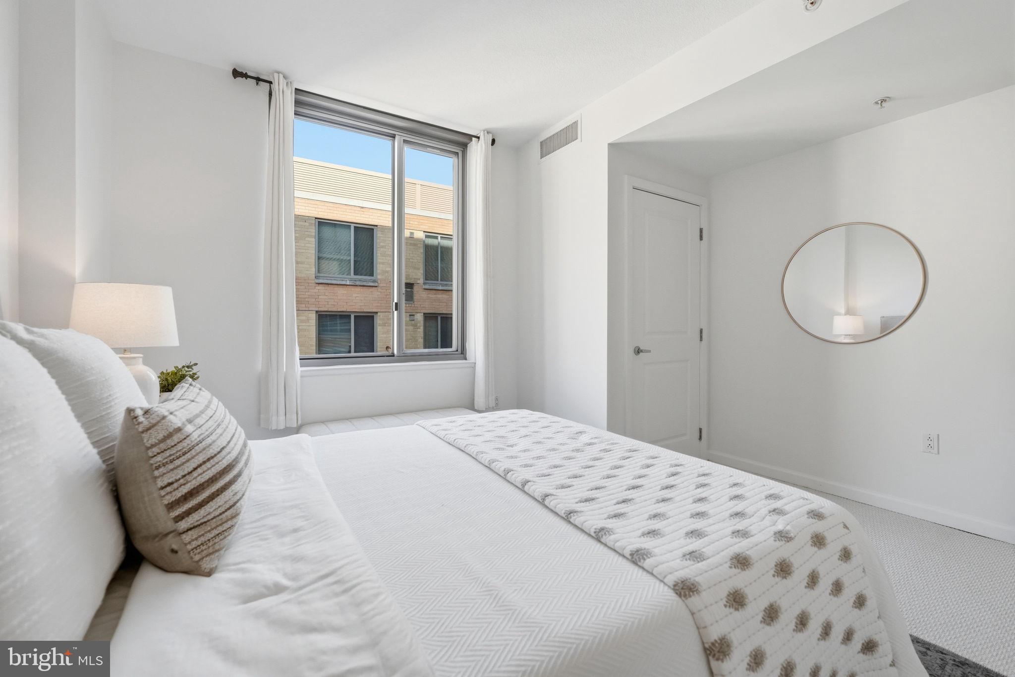 440 L Street Northwest, Unit 809 Washington, DC 20001 - Photo 17 of 50 a bedroom with a bed and a window