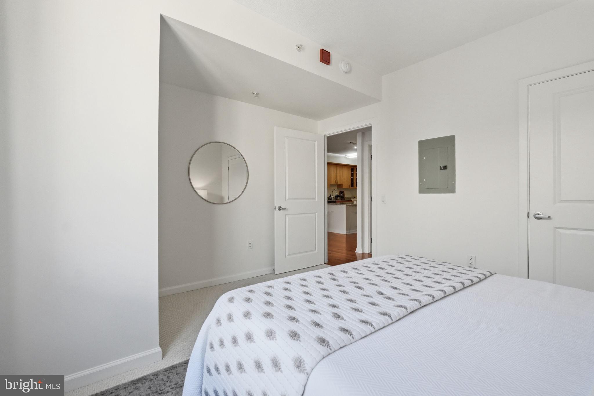 440 L Street Northwest, Unit 809 Washington, DC 20001 - Photo 18 of 50 a bedroom with a bed and a mirror