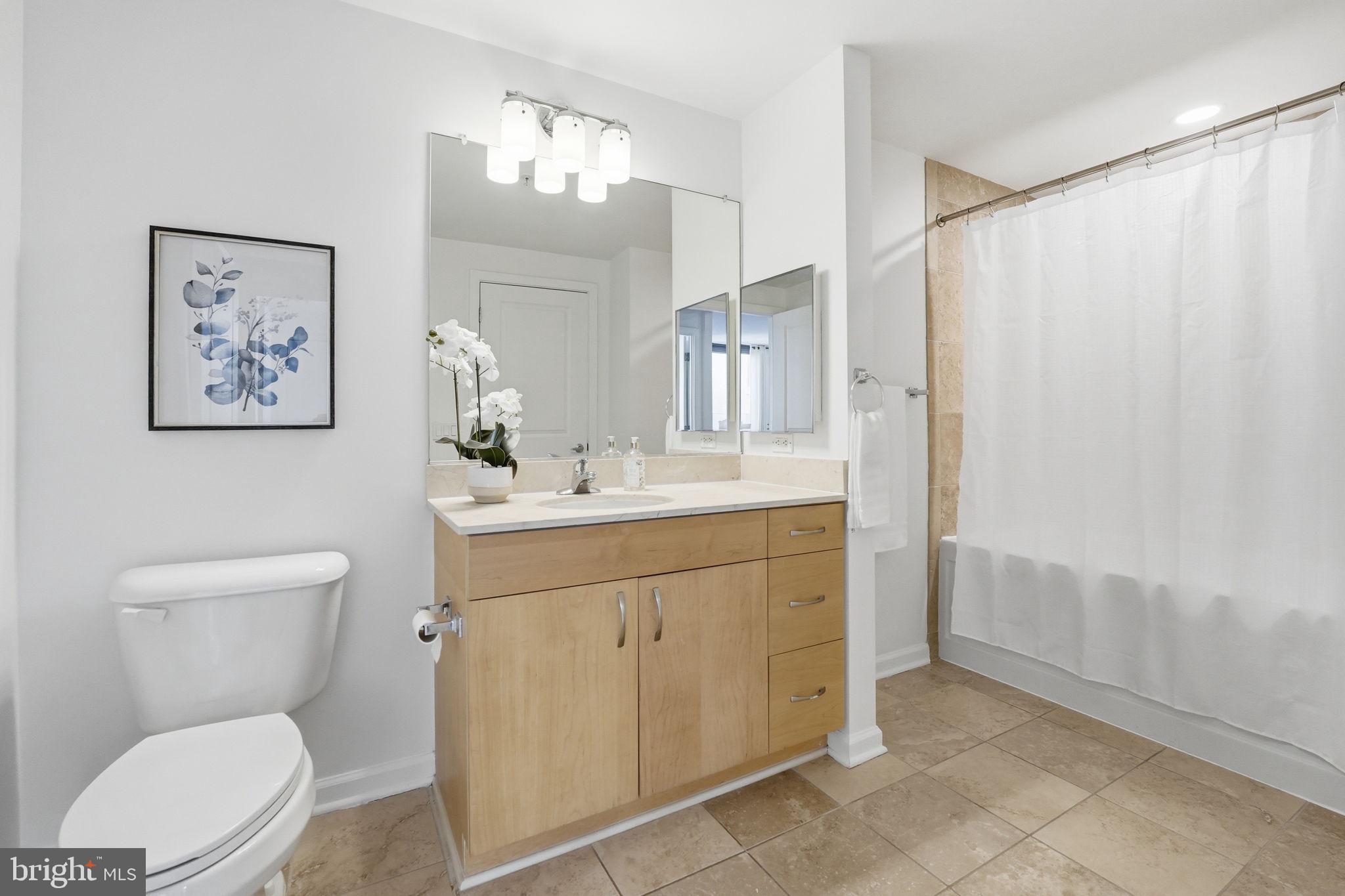 440 L Street Northwest, Unit 809 Washington, DC 20001 - Photo 22 of 50 a bathroom with a toilet sink and a mirror