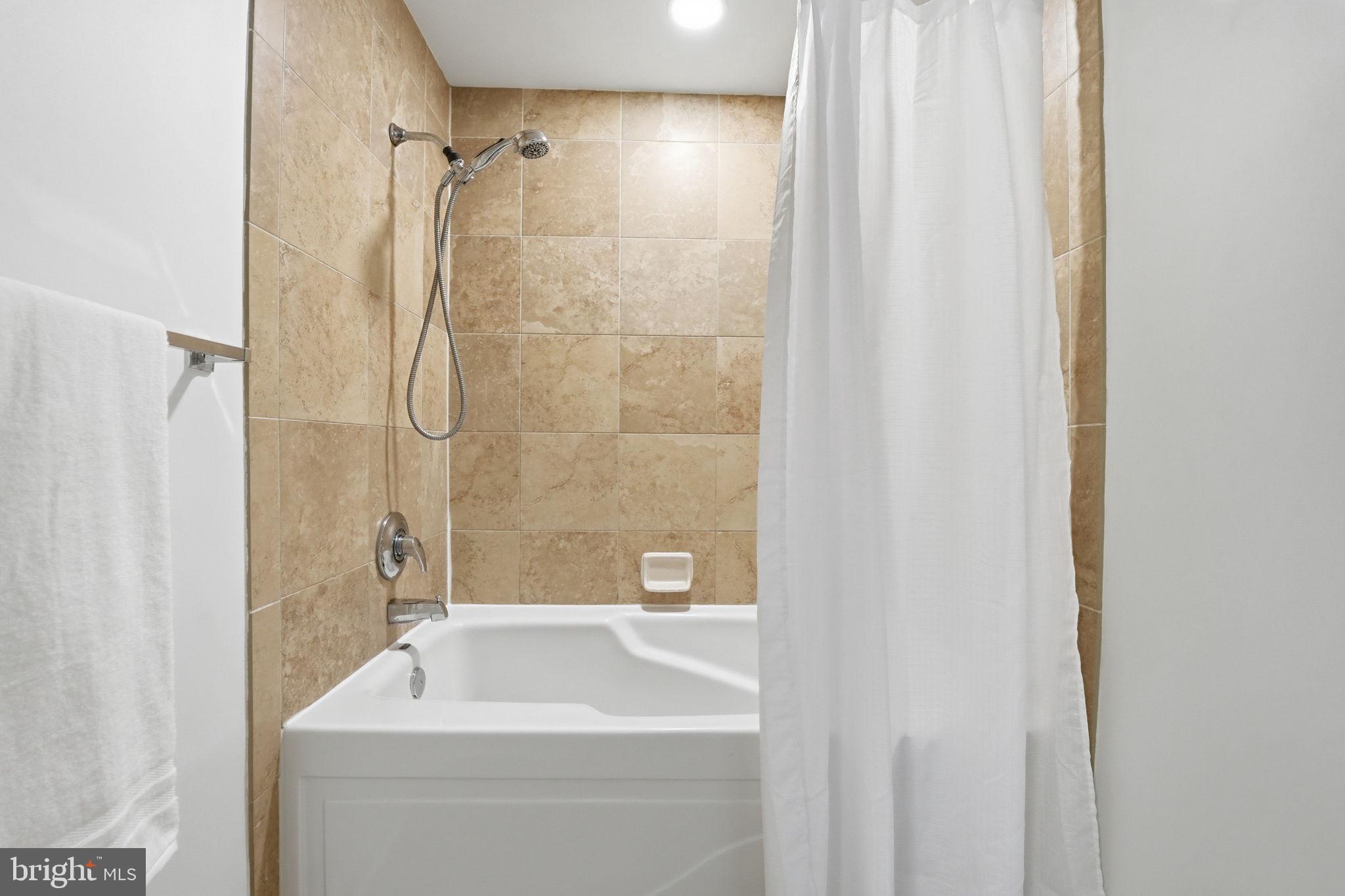 440 L Street Northwest, Unit 809 Washington, DC 20001 - Photo 23 of 50 a bathroom with a sink a mirror and a bathtub