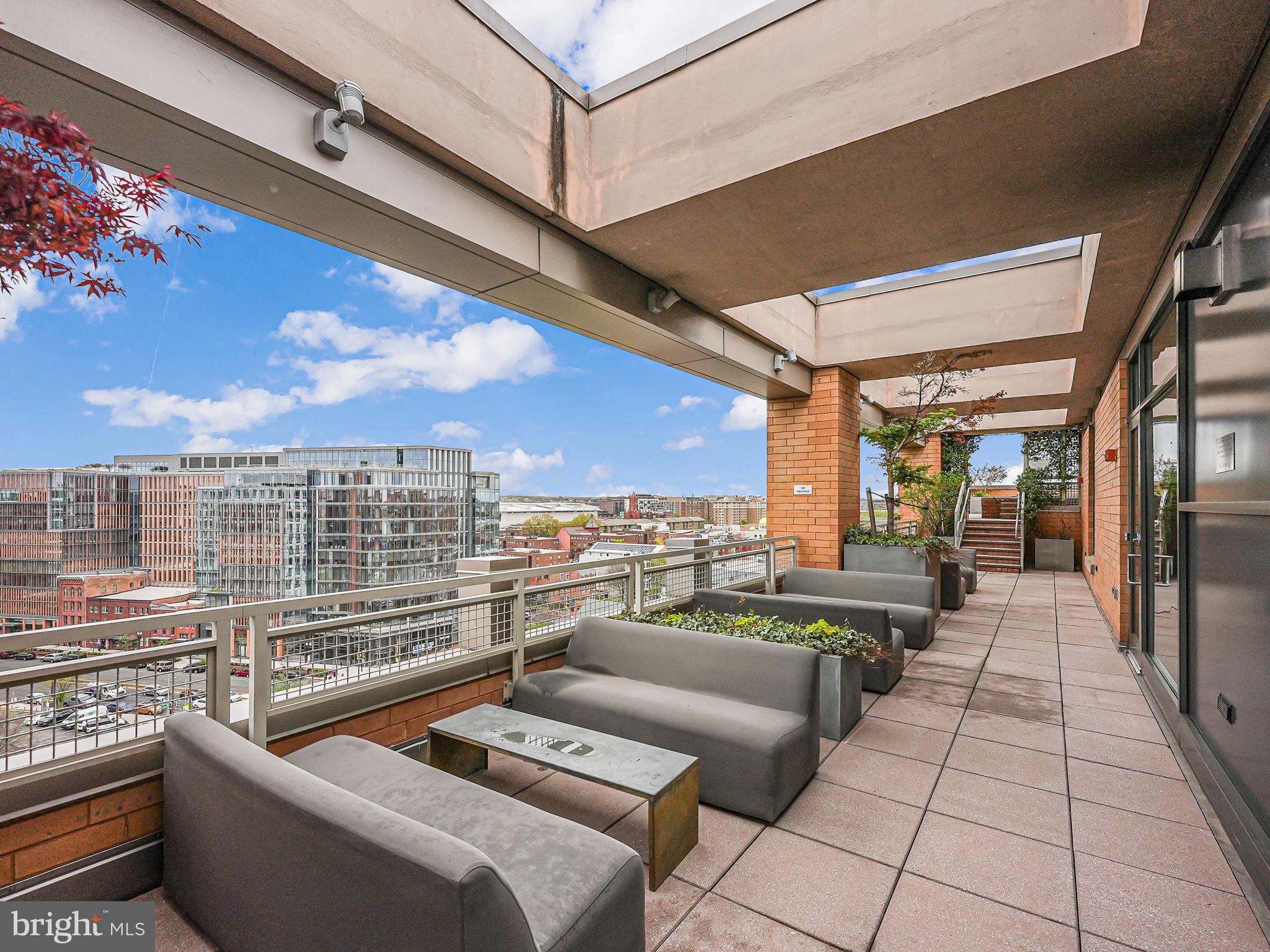 440 L Street Northwest, Unit 809 Washington, DC 20001 - Photo 36 of 50 a view of a balcony with couches and wooden floor