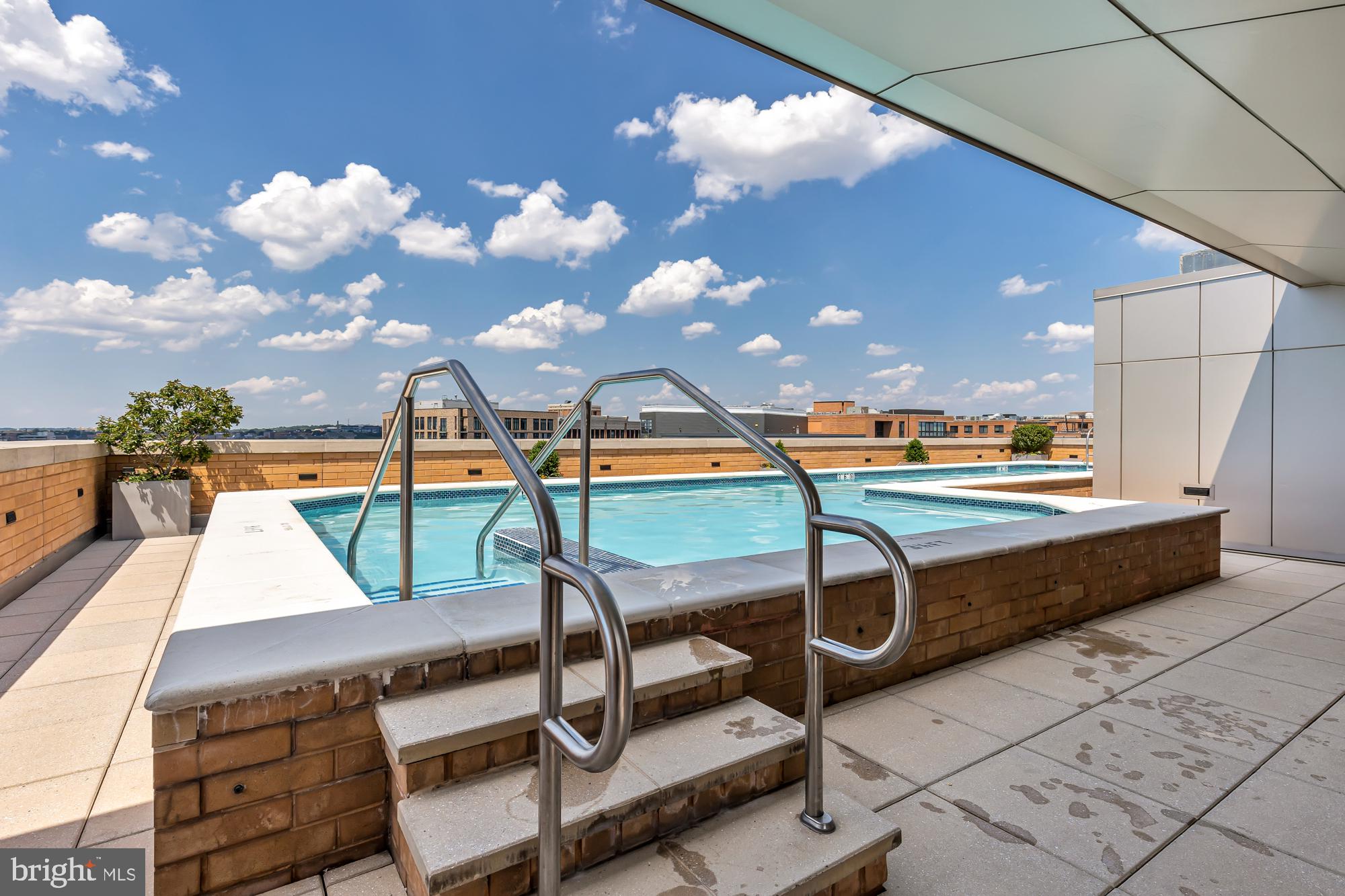440 L Street Northwest, Unit 809 Washington, DC 20001 - Photo 49 of 50 a view of a swimming pool with a lounge chair and a fire pit