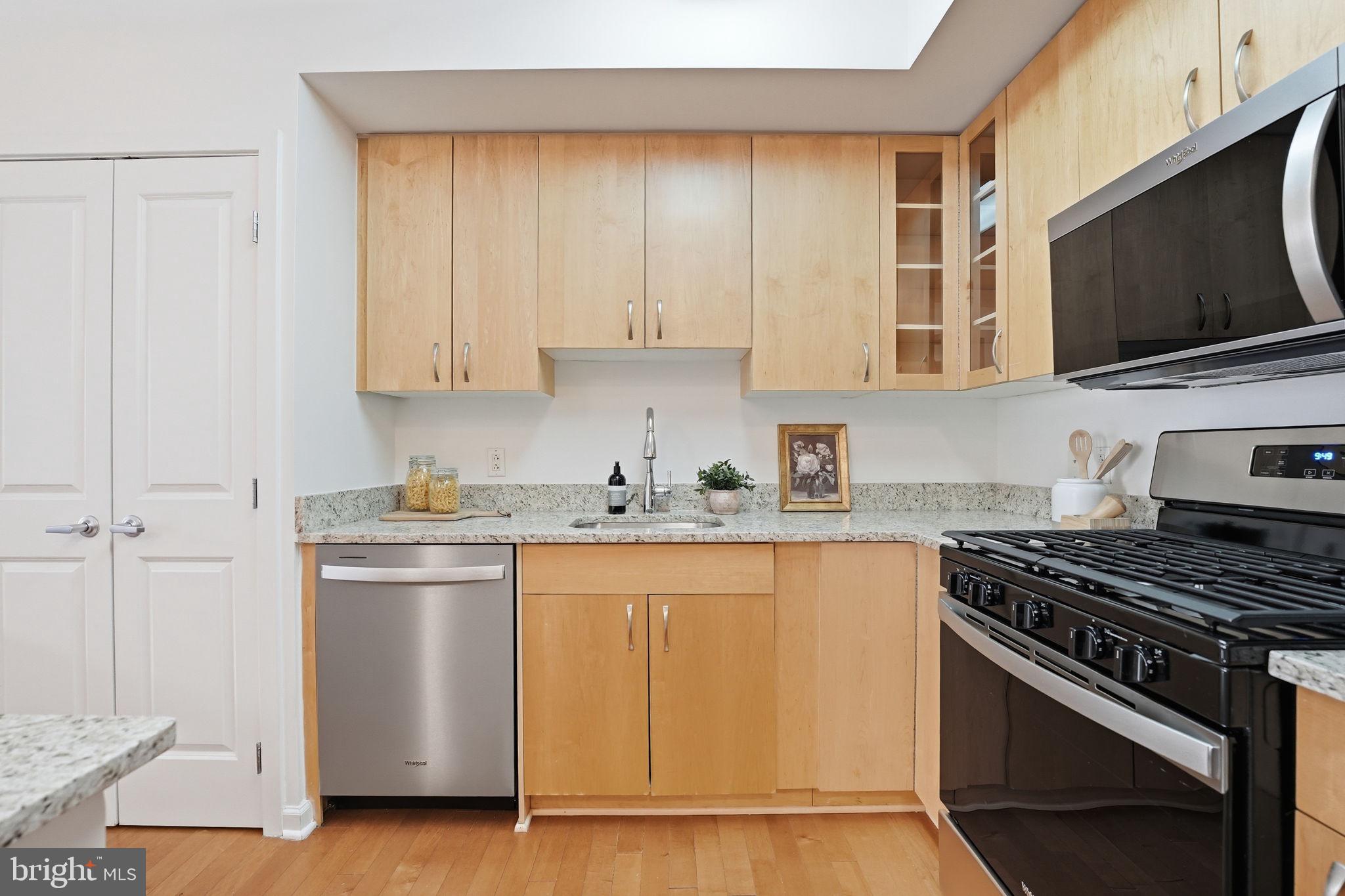 440 L Street Northwest, Unit 809 Washington, DC 20001 - Photo 7 of 50 a kitchen with stainless steel appliances granite countertop a stove and a microwave