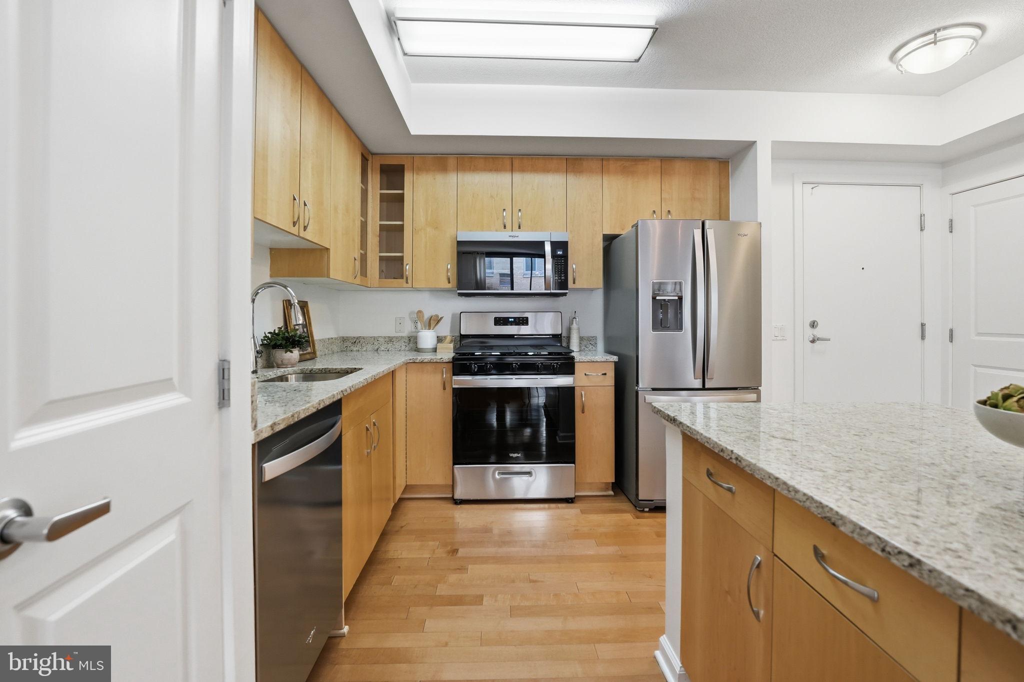 440 L Street Northwest, Unit 809 Washington, DC 20001 - Photo 8 of 50 a kitchen with stainless steel appliances granite countertop a refrigerator and a stove
