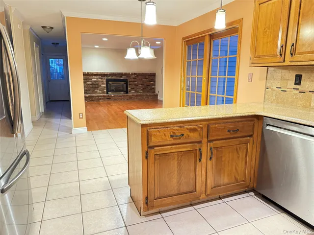 a view of a kitchen with stainless steel appliances granite countertop a refrigerator and a sink
