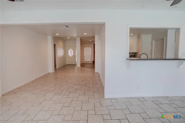 a view of a hallway with wooden floor and a mirror