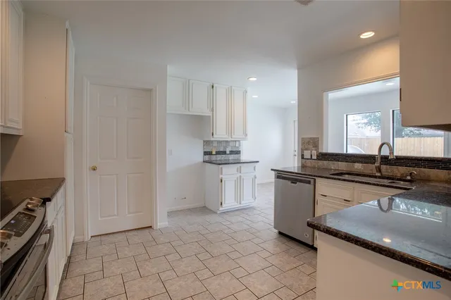 a kitchen with a sink and cabinets