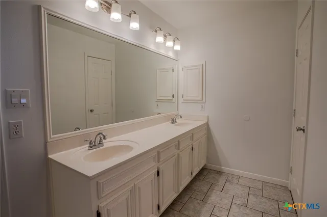 a bathroom with a sink a vanity and shower