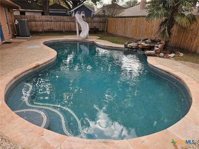 a view of a swimming pool with outdoor seating