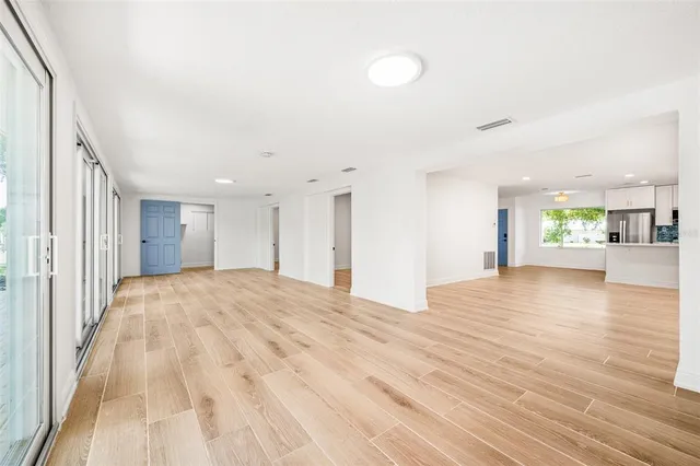 a view of an empty room and wooden floor