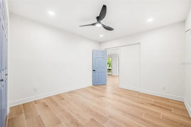 a view of empty room with ceiling fan