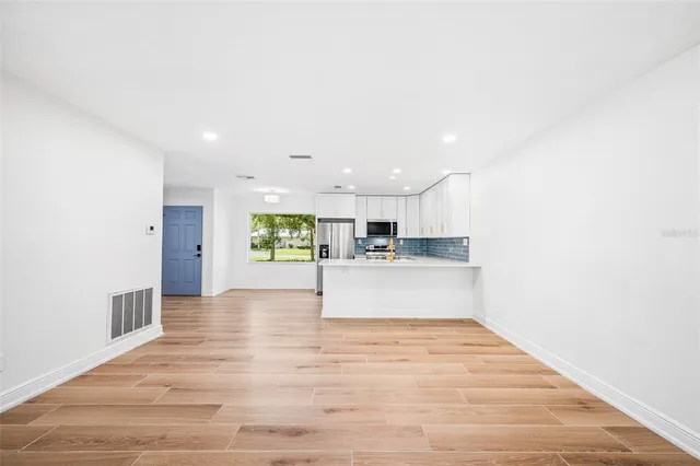a view of kitchen with kitchen island sink and center island