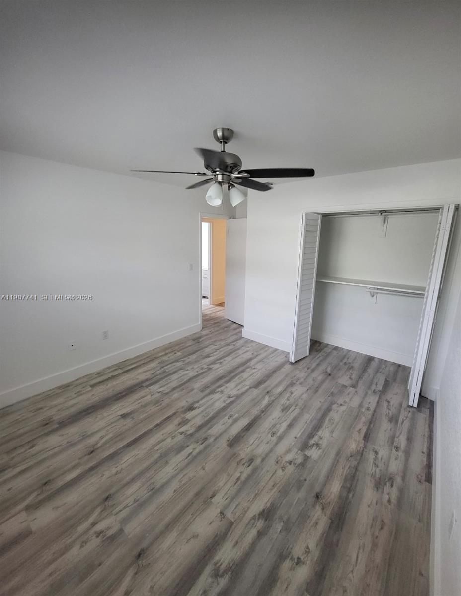 1467 Southwest 3rd Street, Unit 2 Miami, FL 33135 - Photo 5 of 14 a view of a room with wooden floor and a ceiling fan
