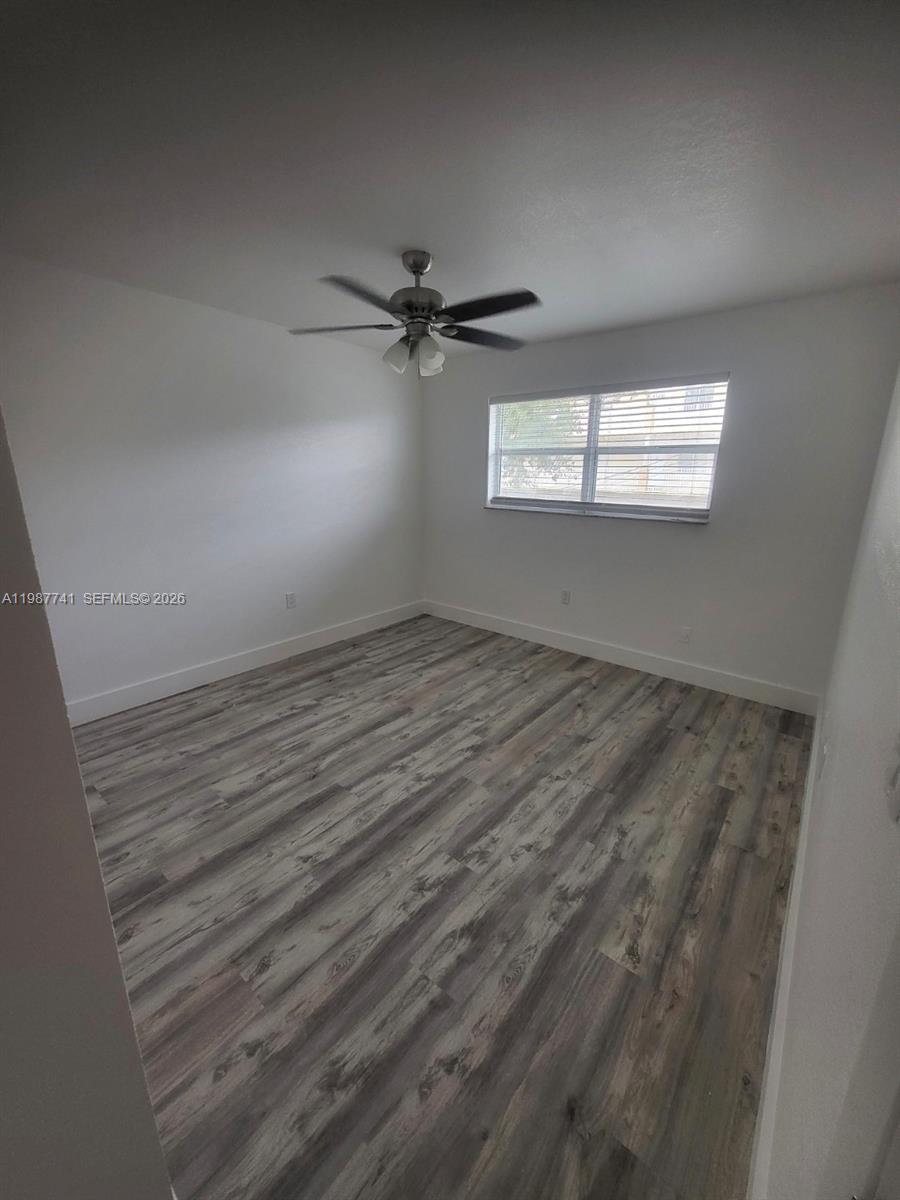 1467 Southwest 3rd Street, Unit 2 Miami, FL 33135 - Photo 6 of 14 an empty room with windows and fan