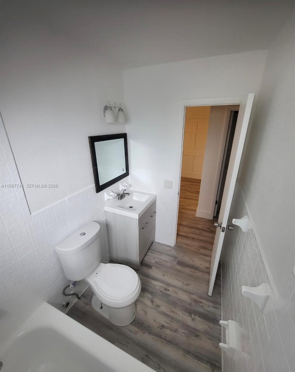 1467 Southwest 3rd Street, Unit 2 Miami, FL 33135 - Photo 7 of 14 a white toilet sitting next to a bathroom sink