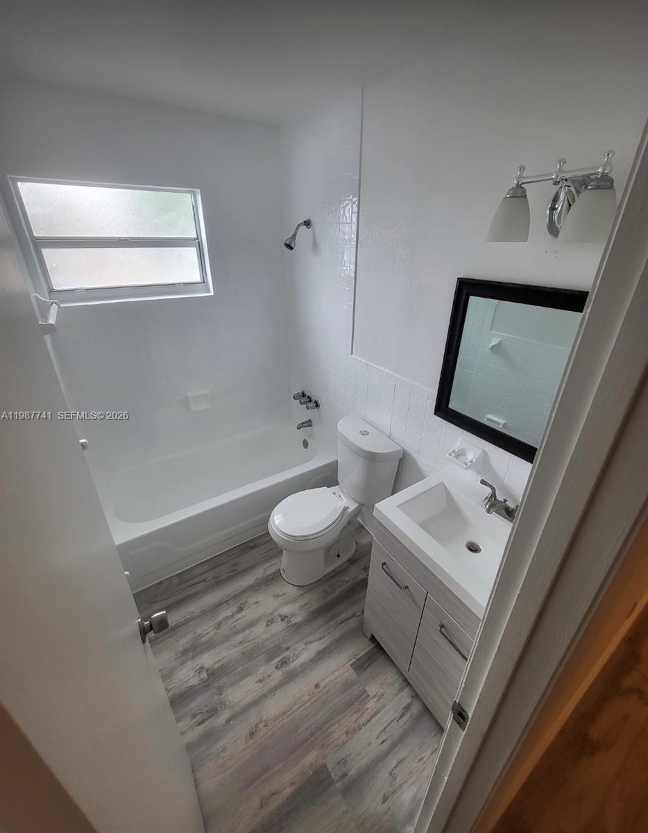 1467 Southwest 3rd Street, Unit 2 Miami, FL 33135 - Photo 8 of 14 a bathroom with a toilet sink and mirror