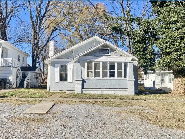 a house with trees in the background