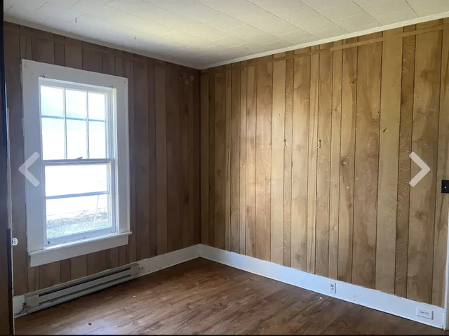a view of a room with a wooden door