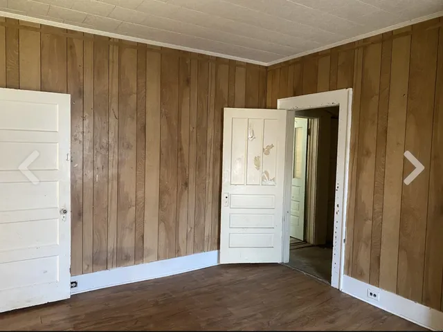 a view of an entryway with wooden floor
