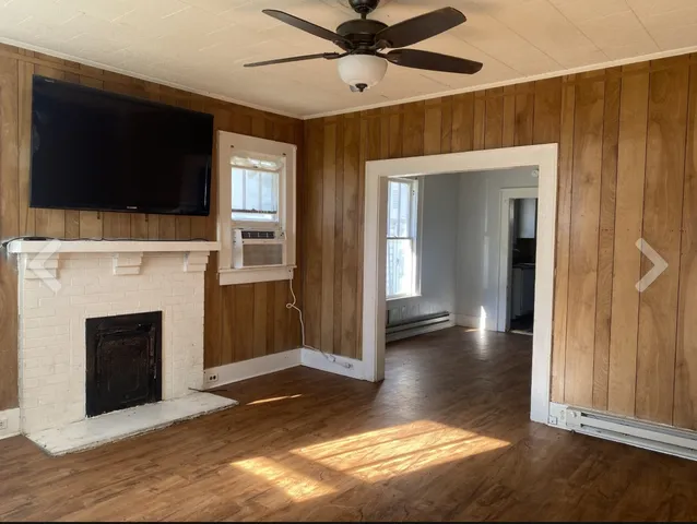 a view of a livingroom with a fireplace and window