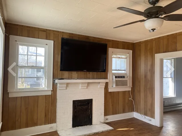 a living room with a flat screen tv and a fireplace