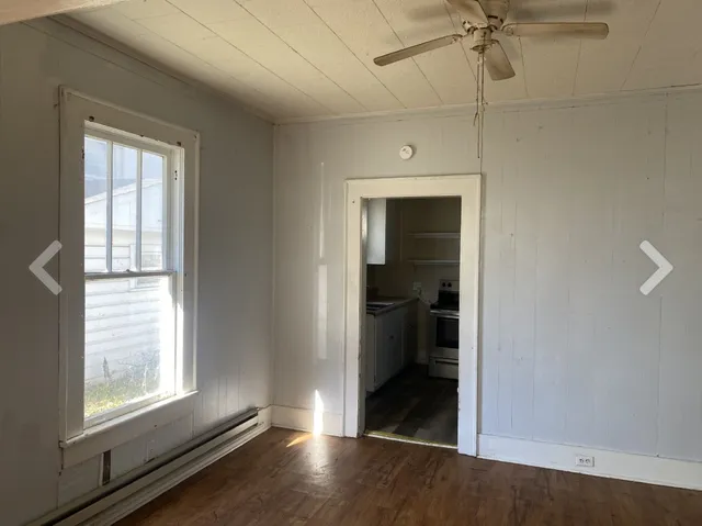 an empty room with windows and closet