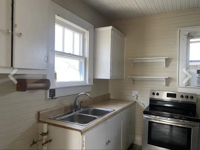 a kitchen that has a sink and a stove