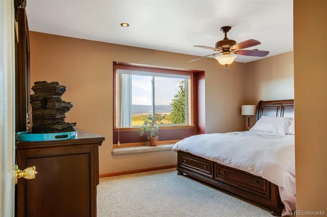 a bedroom with a bed dresser and a window