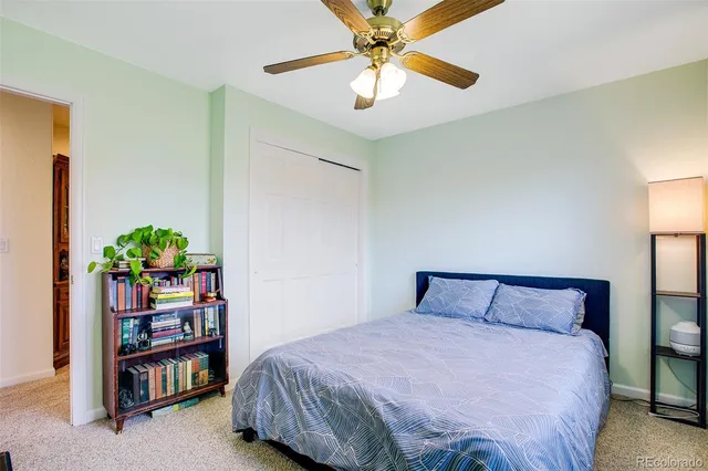 a bedroom with a bed and a potted plant