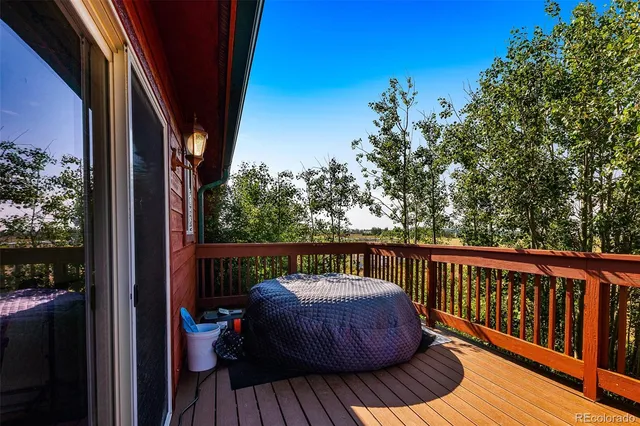 a view of balcony with wooden floor and outdoor seating