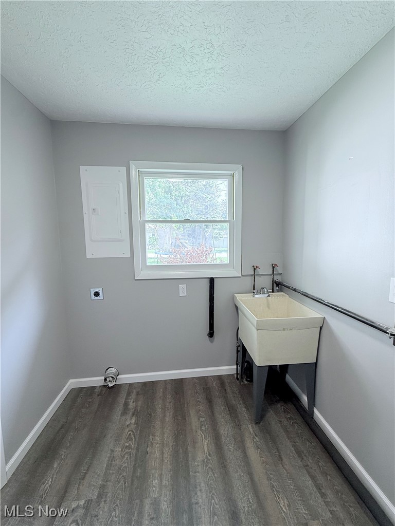 4816 Wake Robin Road Mentor, OH 44060 - Photo 10 of 19 Laundry area featuring dark wood-style floors, electric dryer hookup, hookup for a washing machine, a textured ceiling, and electric panel