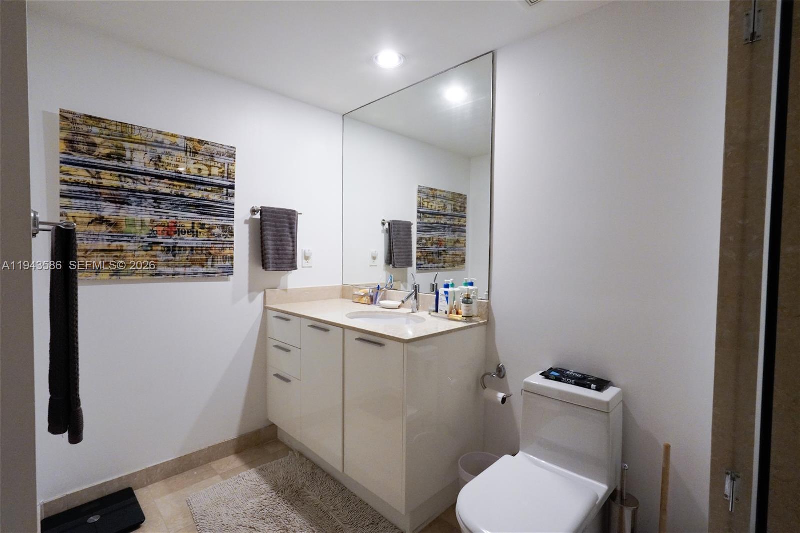 400 Alton Road, Unit 1709 Miami Beach, FL 33139 - Photo 11 of 16 a bathroom with a sink toilet and mirror