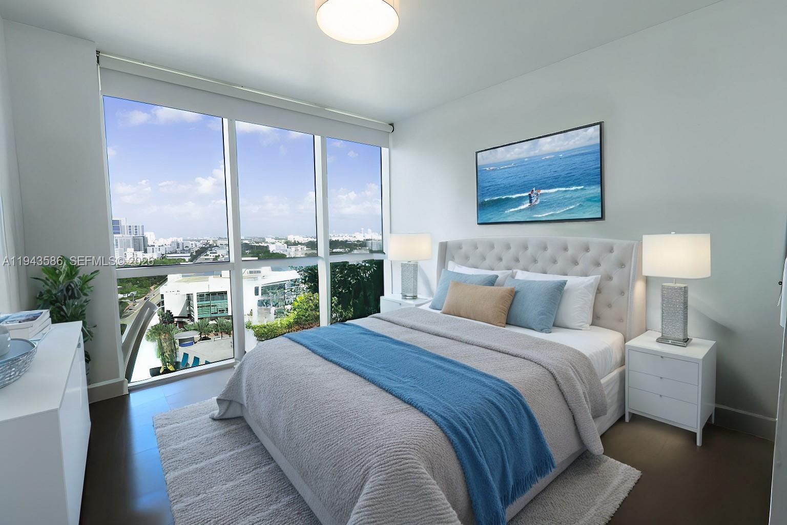 400 Alton Road, Unit 1709 Miami Beach, FL 33139 - Photo 12 of 16 a bedroom with a bed and a large window