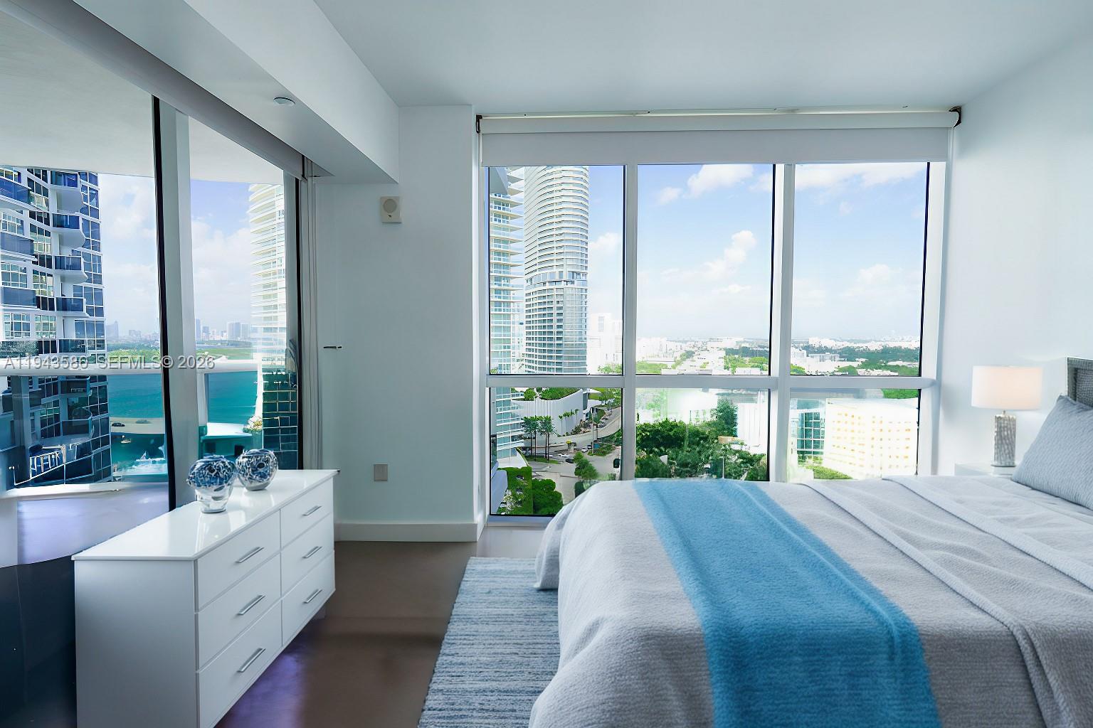 400 Alton Road, Unit 1709 Miami Beach, FL 33139 - Photo 13 of 16 a spacious bedroom with a large bed and a large window