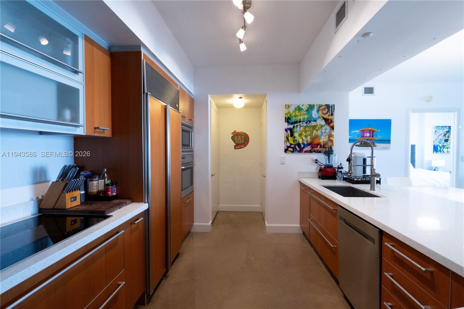 400 Alton Road, Unit 1709 Miami Beach, FL 33139 - Photo 5 of 16 a kitchen with stainless steel appliances a sink stove and cabinets