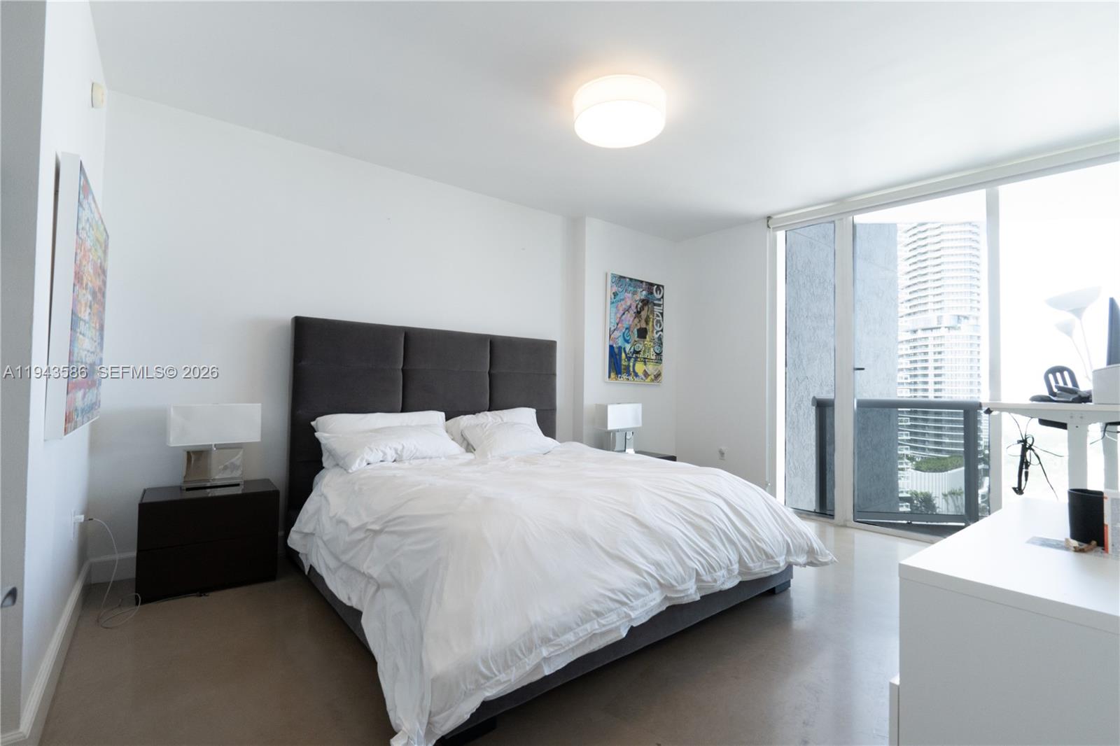 400 Alton Road, Unit 1709 Miami Beach, FL 33139 - Photo 7 of 16 a bedroom with a bed and a night stand