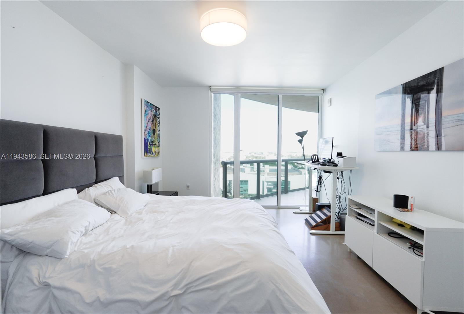 400 Alton Road, Unit 1709 Miami Beach, FL 33139 - Photo 8 of 16 a spacious bedroom with a bed and a large window