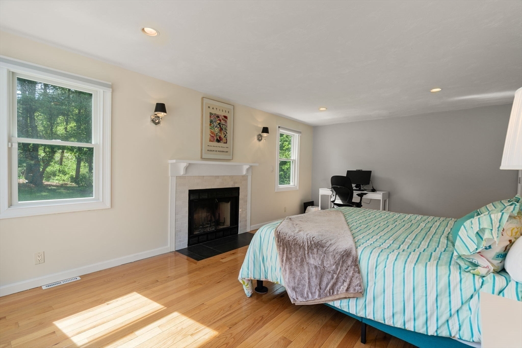 11 Cow Hill Road Sharon, MA 02067 - Photo 17 of 30 a bedroom with a bed and a fireplace