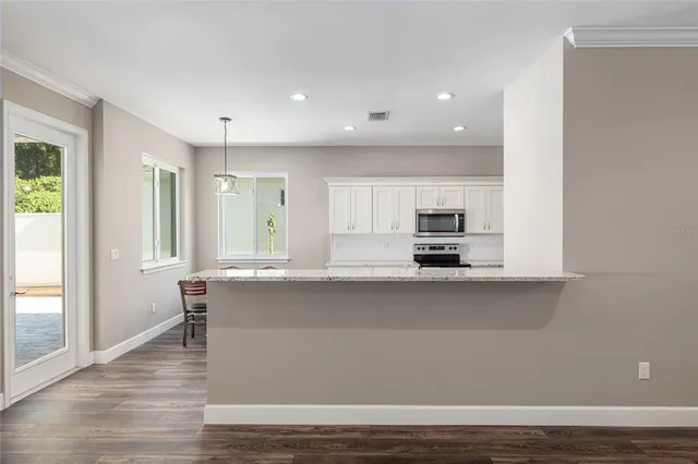 a view of a dining room with furniture window and wooden floor