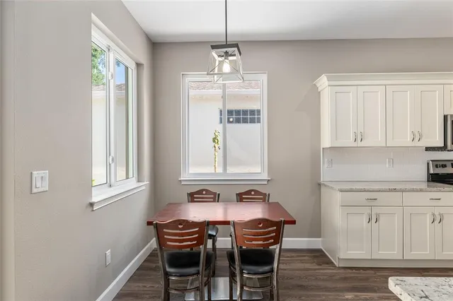 a kitchen with stainless steel appliances granite countertop a sink and a wooden floors