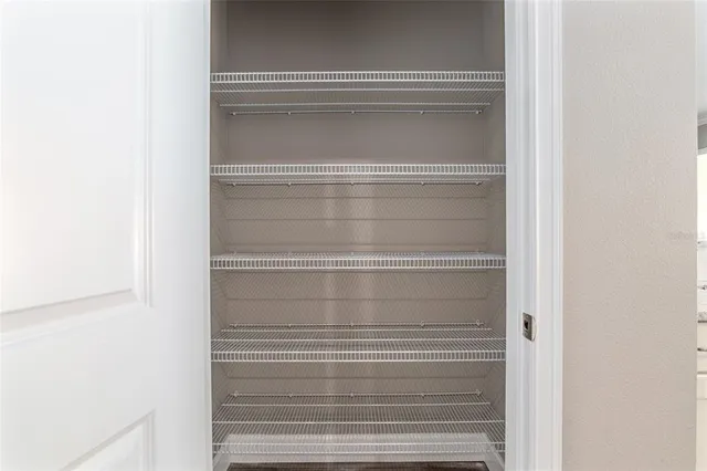 a bedroom with a bed and a lamp