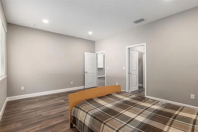 a bathroom with a granite countertop sink a mirror and a shower