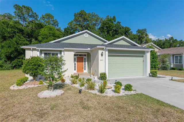 a front view of a house with a yard and garage