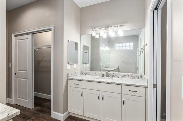 a bathroom with a glass shower door